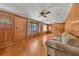 Classic living room with wood paneled walls and hardwood flooring, featuring neutral colored furniture at 434 Terrace Sw Dr, Smyrna, GA 30082