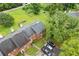 Aerial view of the property showing lush landscaping, gray roof, and private parking at 4691 Shumate Dr, Stone Mountain, GA 30083
