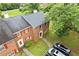 Aerial view showcasing the brick exterior, gray roof, and well-manicured lawn at 4691 Shumate Dr, Stone Mountain, GA 30083