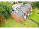 Aerial view of the brick home featuring backyard with fence and patio, plus green lawn at 4691 Shumate Dr, Stone Mountain, GA 30083