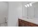 Bathroom with a mirror over the counter with a sink, toilet on the side at 4691 Shumate Dr, Stone Mountain, GA 30083