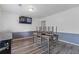 Dining area featuring modern gray accents, wood-look flooring, and a mounted TV for entertaining at 4691 Shumate Dr, Stone Mountain, GA 30083