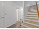 Hallway with stairs, wood-look flooring, and neutral paint. A simple, yet classic, design at 4691 Shumate Dr, Stone Mountain, GA 30083