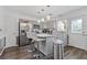 Modern kitchen featuring sleek gray cabinets, stainless steel appliances, and stylish island with pendant lighting at 4691 Shumate Dr, Stone Mountain, GA 30083