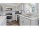 Modern kitchen with gray cabinets, stainless steel appliances, and light countertops that add brightness at 4691 Shumate Dr, Stone Mountain, GA 30083
