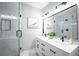 Modern bathroom featuring double sinks, white marble, and a glass walk-in shower at 943 Rose Sw Cir, Atlanta, GA 30310