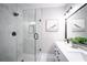 Bathroom featuring a glass shower with black hardware and white marble tiling at 943 Rose Sw Cir, Atlanta, GA 30310