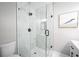 Close-up of the glass shower featuring white marble tiling and black hardware at 943 Rose Sw Cir, Atlanta, GA 30310