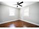 Bright bedroom with hardwood floors, neutral walls, and natural light from two windows at 943 Rose Sw Cir, Atlanta, GA 30310