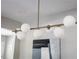 Close-up of a modern chandelier with white spherical lights, adding a stylish touch to the interior design at 943 Rose Sw Cir, Atlanta, GA 30310