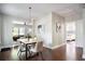 Open dining area with hardwood floors, modern lighting, and seamless access to the living room and bedroom at 943 Rose Sw Cir, Atlanta, GA 30310