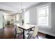 Open concept dining room with hardwood floors and modern lighting fixture adjacent to the renovated kitchen at 943 Rose Sw Cir, Atlanta, GA 30310