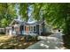 Beautifully renovated home featuring a long driveway and inviting front porch with a fresh coat of paint at 943 Rose Sw Cir, Atlanta, GA 30310