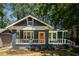 Charming renovated home with a freshly painted exterior, inviting porch, and well-manicured front yard at 943 Rose Sw Cir, Atlanta, GA 30310