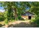 Exterior view of a detached garage in a private, wooded backyard at 943 Rose Sw Cir, Atlanta, GA 30310