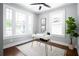 Bright home office with hardwood floors, white walls, and a modern desk at 943 Rose Sw Cir, Atlanta, GA 30310