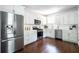 Updated kitchen featuring stainless steel appliances, white cabinets and stone countertops at 943 Rose Sw Cir, Atlanta, GA 30310