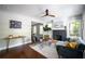 Open-concept living room with hardwood floors, fireplace and a seamless flow to the dining area at 943 Rose Sw Cir, Atlanta, GA 30310