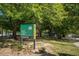 Rose Circle Park sign surrounded by mature trees and lush greenery in a city park at 943 Rose Sw Cir, Atlanta, GA 30310