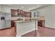This kitchen has stainless steel appliances, brown cabinets, granite counters and a center island with sink at 1354 Slate Bend Dr, Dacula, GA 30019