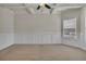 Bright living room featuring decorative ceiling, large window, neutral carpet, and wainscoting at 1354 Slate Bend Dr, Dacula, GA 30019