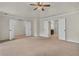 Spacious main bedroom featuring plush carpeting, ceiling fan, and ensuite bathroom entrance at 1354 Slate Bend Dr, Dacula, GA 30019