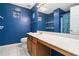 Stylish bathroom featuring blue walls, vanity, and tub/shower combo at 139 W Oaks Pl, Woodstock, GA 30188
