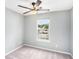Neutral bedroom featuring ceiling fan, window, and carpeted floor at 139 W Oaks Pl, Woodstock, GA 30188