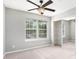 Serene bedroom featuring a ceiling fan, natural light, and a mirrored closet at 139 W Oaks Pl, Woodstock, GA 30188