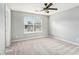 Spacious bedroom with plush carpet, a ceiling fan, and ample natural light at 139 W Oaks Pl, Woodstock, GA 30188