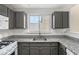 Well-lit kitchen featuring granite countertops, white subway tile backsplash, and modern stainless steel appliances at 139 W Oaks Pl, Woodstock, GA 30188