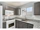 Well-lit kitchen featuring granite countertops, white subway tile backsplash, and modern stainless steel appliances at 139 W Oaks Pl, Woodstock, GA 30188