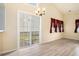 Bright living room featuring a vaulted ceiling, ceiling fan, and sliding glass doors to the backyard at 139 W Oaks Pl, Woodstock, GA 30188