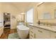 Bright bathroom featuring a soaking tub, double vanity with granite countertop and elegant gold fixtures at 2602 Corey Park Dr, Loganville, GA 30052