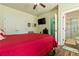 Inviting bedroom with a red bed, TV and an open doorway to a bathroom at 2602 Corey Park Dr, Loganville, GA 30052