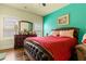 Comfortable bedroom with a dresser, large windows, and a red bed at 2602 Corey Park Dr, Loganville, GA 30052