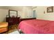 Comfortable bedroom featuring a wooden dresser, decorative items, and a cozy bedspread at 2602 Corey Park Dr, Loganville, GA 30052