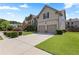 Spacious driveway leads to a well-maintained two-story home with a two-car garage at 2602 Corey Park Dr, Loganville, GA 30052