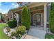 Inviting front porch features a brick facade and a well-manicured garden at 2602 Corey Park Dr, Loganville, GA 30052