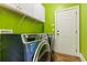 Well lit laundry room with shelving and modern washer and dryer at 2602 Corey Park Dr, Loganville, GA 30052