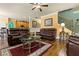 Spacious living room with leather furniture, hardwood floors, and adjacent dining area and staircase at 2602 Corey Park Dr, Loganville, GA 30052