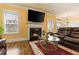 Inviting living room with fireplace, flatscreen TV, leather sofa and hardwood floors at 2602 Corey Park Dr, Loganville, GA 30052