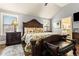 Large main bedroom with a decorative bed, hardwood floors, natural light, and a sitting area at 2602 Corey Park Dr, Loganville, GA 30052