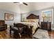 Spacious main bedroom featuring a detailed bed frame, ceiling fan, and natural light at 2602 Corey Park Dr, Loganville, GA 30052