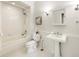 Cozy bathroom featuring a tub/shower combo, pedestal sink, and classic fixtures at 273 12Th Ne St # 111, Atlanta, GA 30309