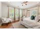 Bright bedroom with hardwood floors, neutral walls, ceiling fan, and three windows for natural light at 273 12Th Ne St # 111, Atlanta, GA 30309