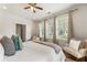 Bright bedroom with hardwood floors, neutral walls, ceiling fan, and three windows for natural light at 273 12Th Ne St # 111, Atlanta, GA 30309
