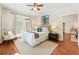Bright bedroom with hardwood floors, neutral walls, ceiling fan, and a set of French doors at 273 12Th Ne St # 111, Atlanta, GA 30309