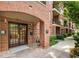 Elegant brick entrance featuring double doors, complemented by lush landscaping and classic architectural details at 273 12Th Ne St # 111, Atlanta, GA 30309
