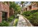 Beautifully landscaped walkway between brick buildings, creating a serene outdoor environment at 273 12Th Ne St # 111, Atlanta, GA 30309